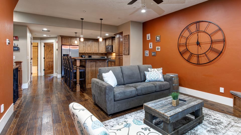 Relax in your cozy living room with a crackling fireplace, comfortable seating, and mountain views from your private balcony.