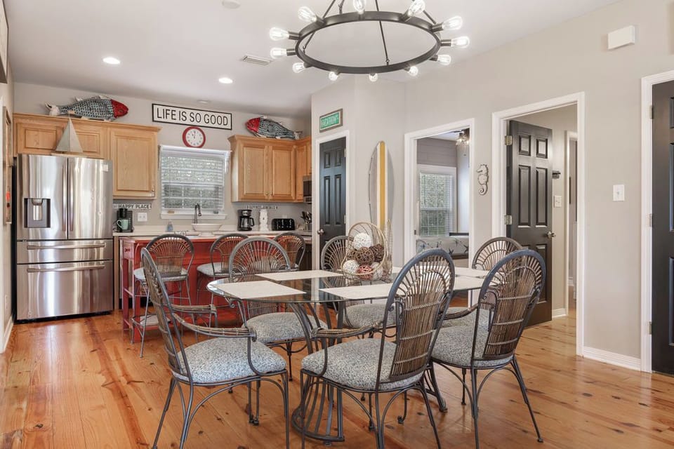 Dining Area - A table with seating for 6 is featured in the open dining area with additional seats offered at the adjacent island.