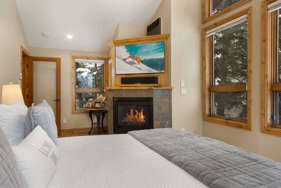 Cozy up in the Primary bedroom, where a gas fireplace and flatscreen TV create the perfect ambiance.