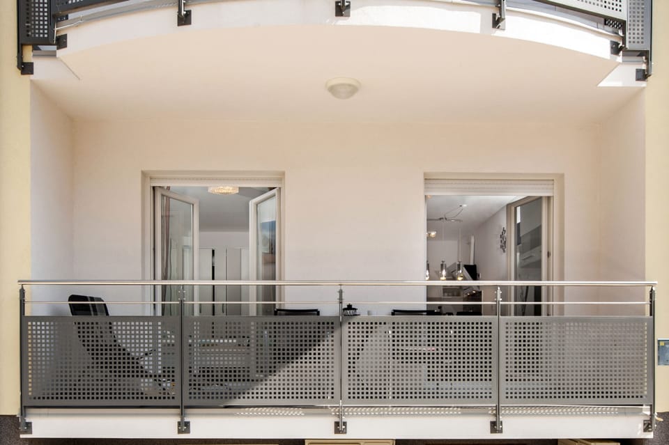 The balcony is easily accessible from both the bedroom and living room.
