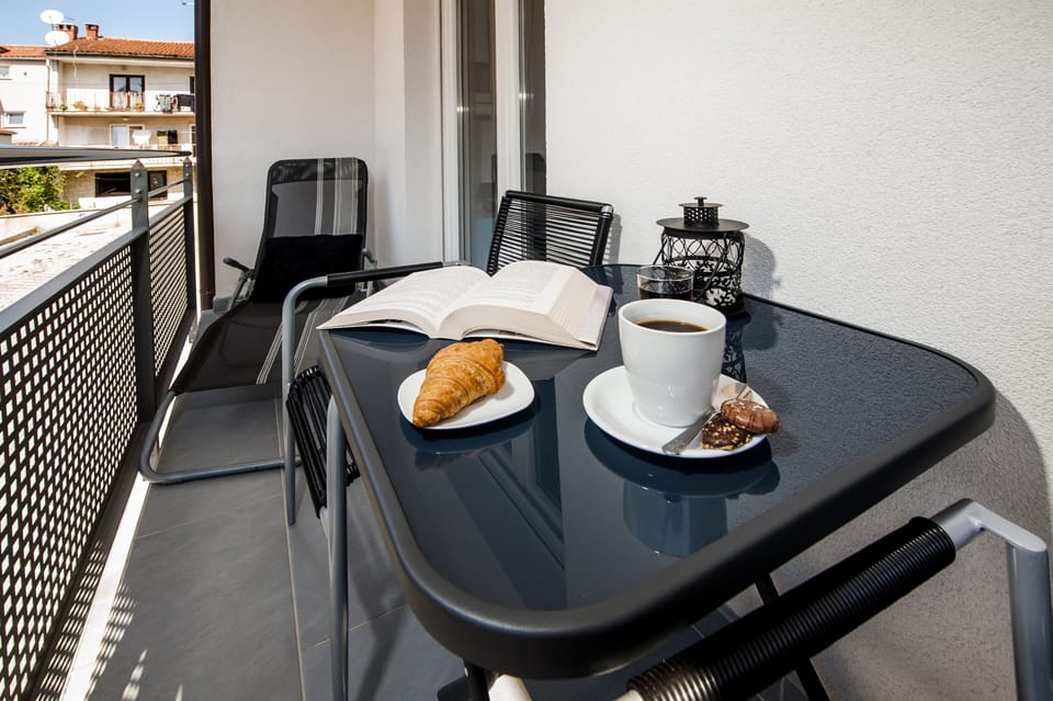 The balcony is a perfect spot to enjoy a cup of coffee.