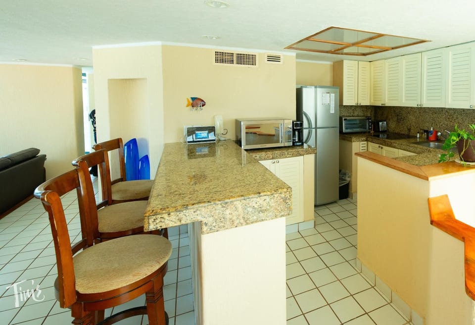 The Kitchen and Breakfast Bar - The Kitchen Cabinets surfaces were also recently updated with a nice finish and new hardware