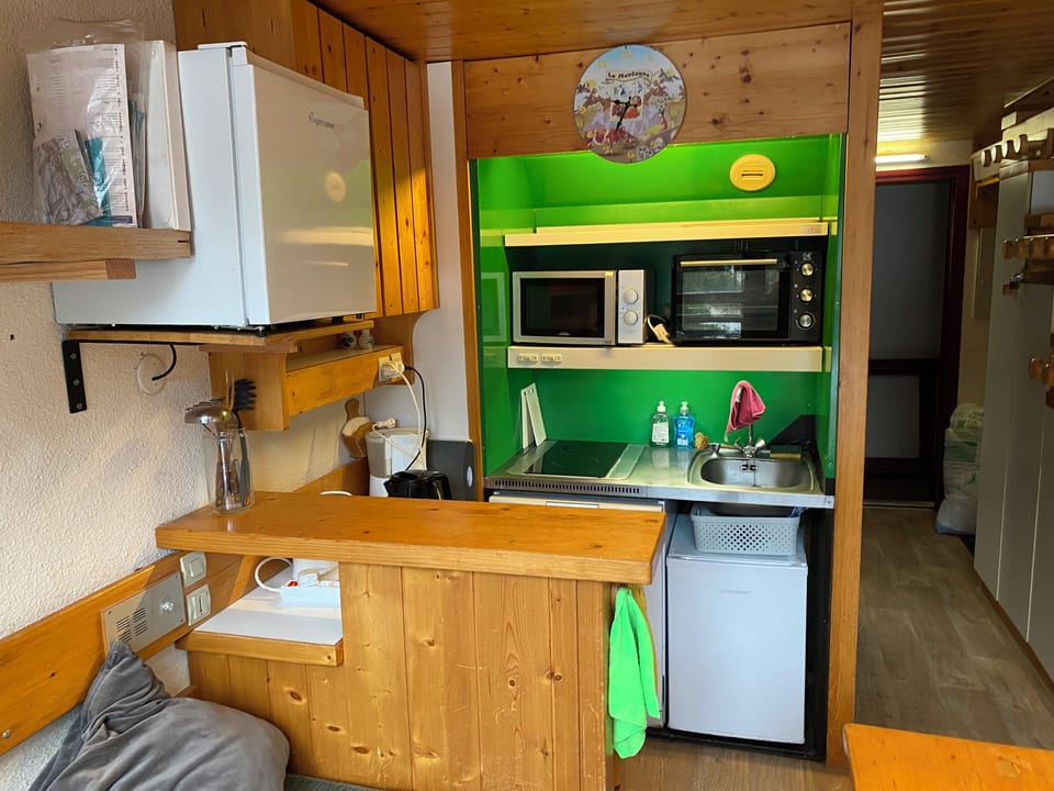 Kitchen photo showing the two fridges with small freezer space in each.