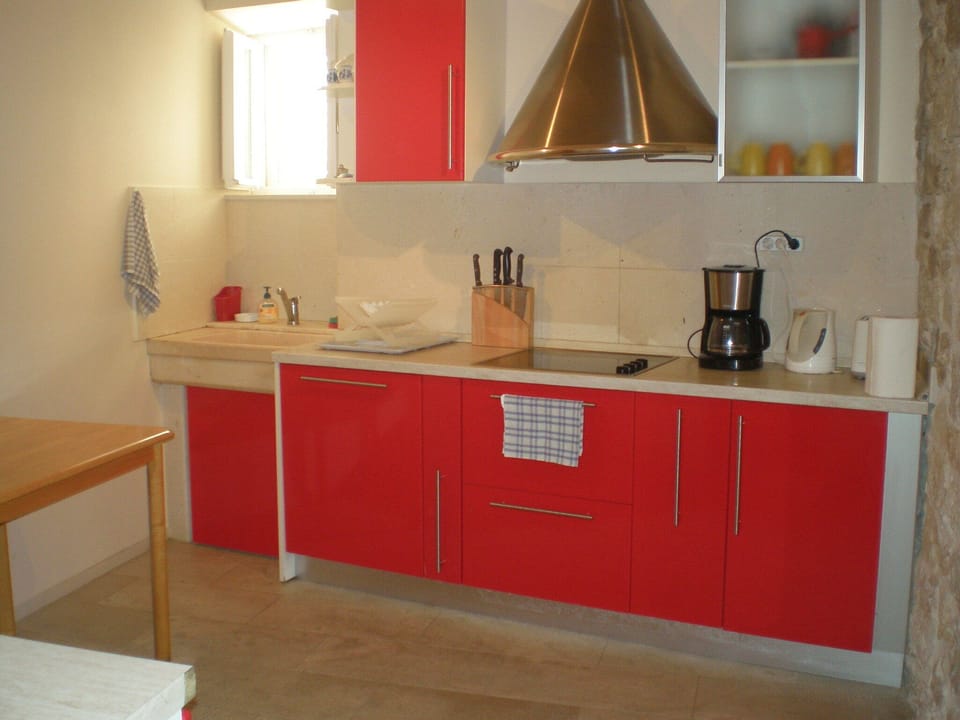 Modern, fully equipped kitchen with solid top cookers and dishwasher.