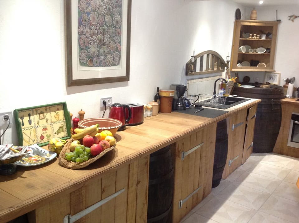 Part of kitchen, with old wine barrels