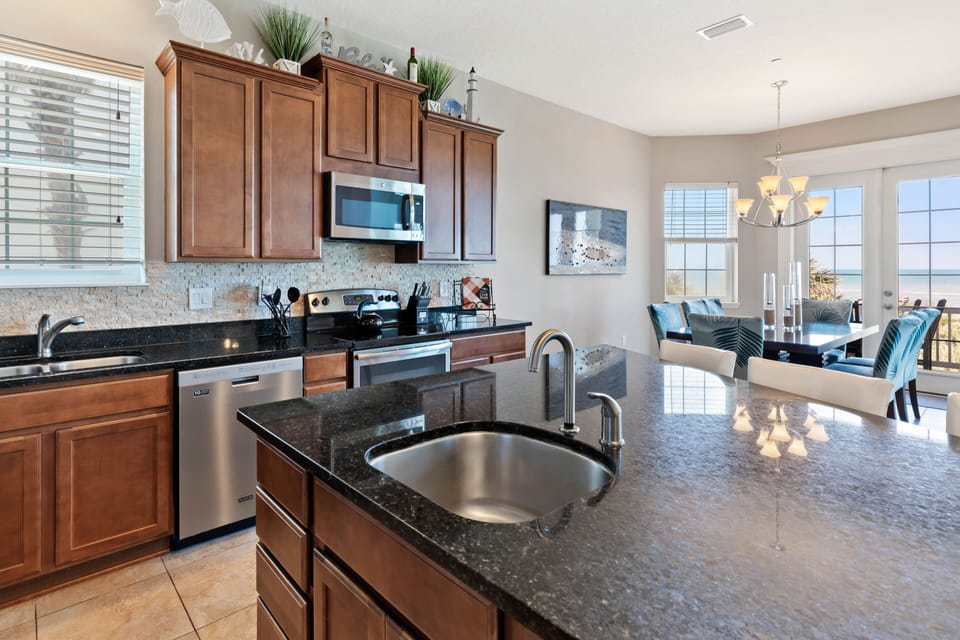 Kitchen with prep sink in the island is ideal for making large family meals together.