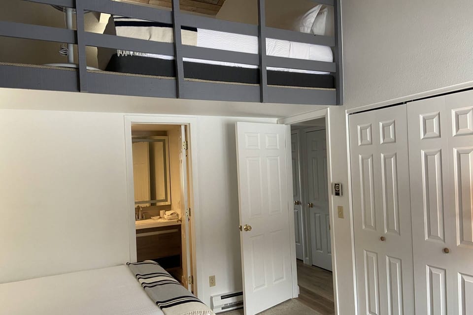 The second bedroom has a newly renovated en-suite bath with a large walk-in shower and a lofted sleeping space.