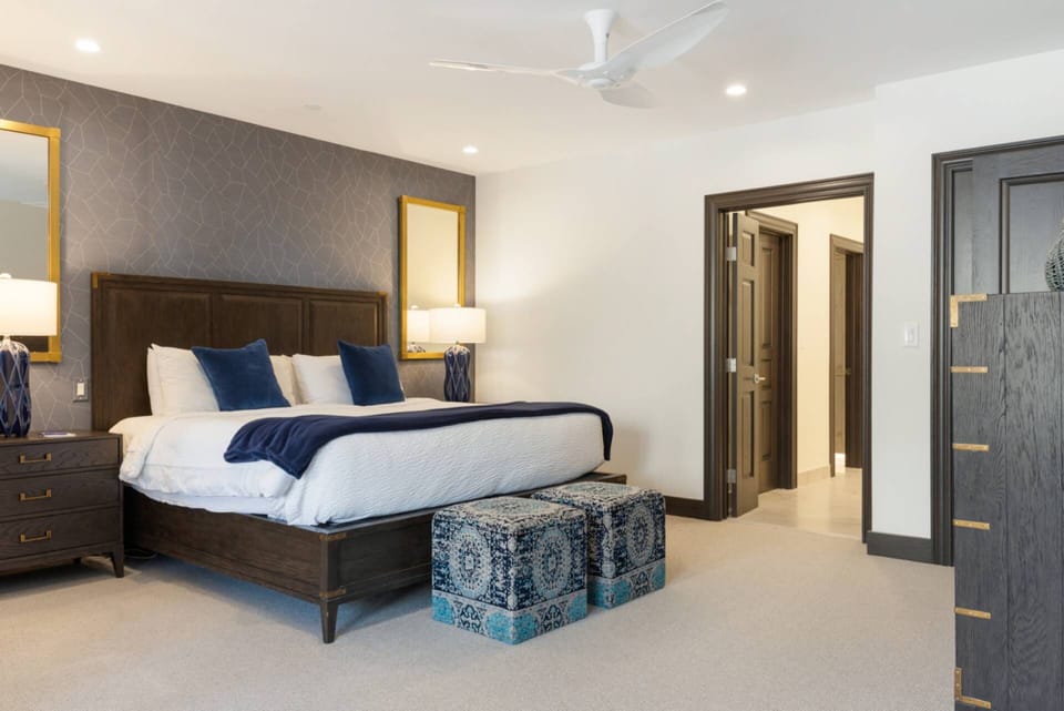 Luxurious primary bedroom featuring a plush kind bed for the ultimate comfort and relaxation.