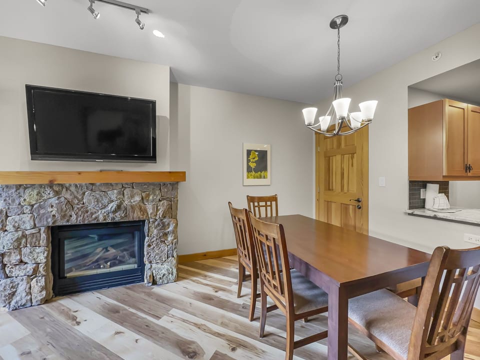 Dining area next to fireplace and TV.