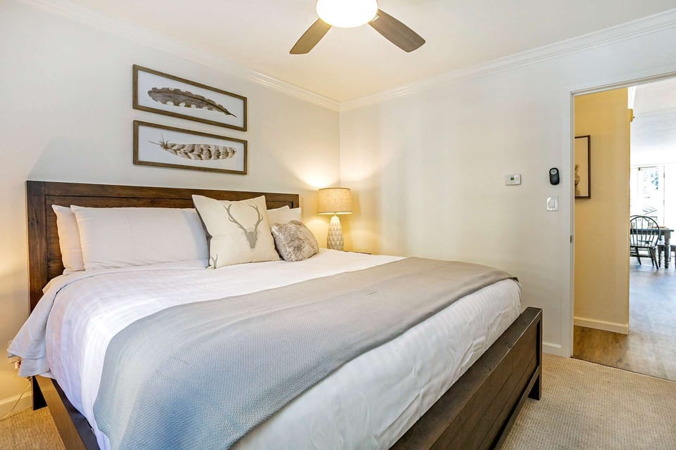 The master bedroom is furnished with a king bed and has access to a full bathroom just steps from the door.