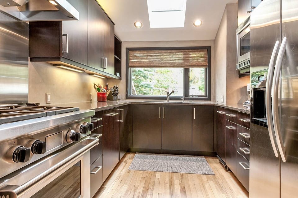 Fully equipped kitchen with ample counter space, Wolfe gas stove with hood system, trash compactor and other stainless accents.
