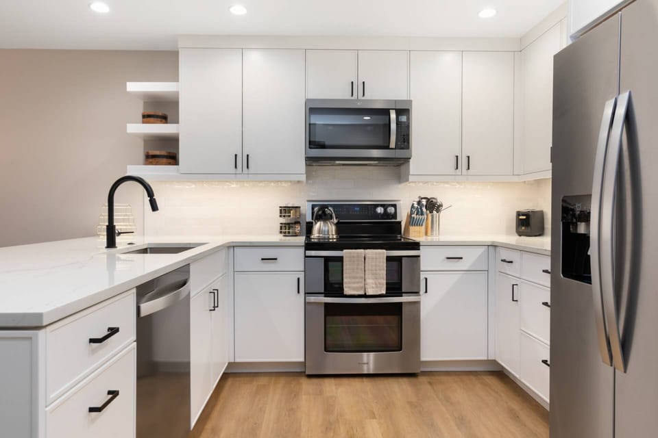 Brand New Kitchen featuring a double oven, microwave, refrigerator with ice maker, toaster, blender, air fryer, and crock pot.