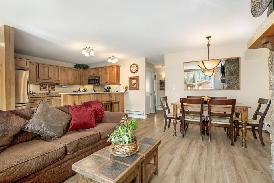 The open-concept kitchen, dining, and living area is perfect for socializing and enjoying mountain views!