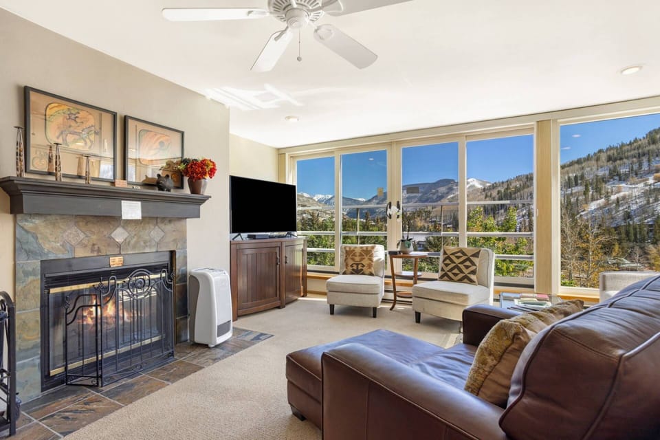 Inviting living space with scenic mountain views and a wood burning fireplace.
