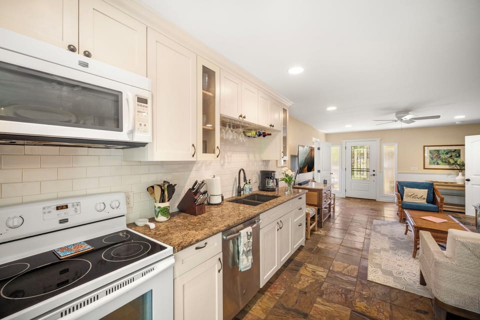 Step into this bright, breezy kitchen and dining space—where tropical vibes meet modern convenience.