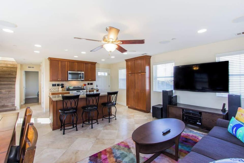 Open concept living room with large TV