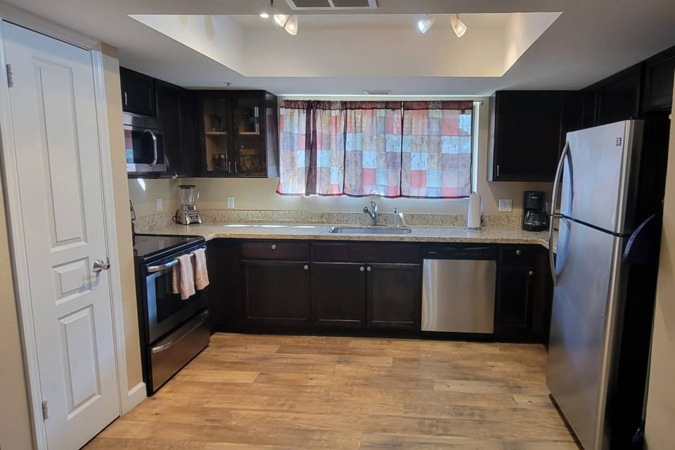 Enjoy the Kitchen with fridge, dishwasher, microwave, flat top stove
