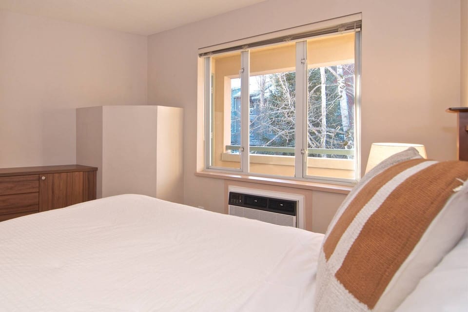Another view of bedroom showing built in dresser  and new AC unit