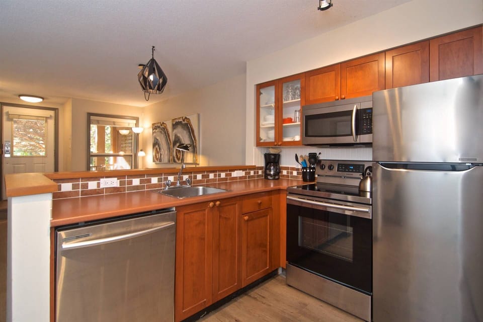Kitchen over looking living area. New engineered plank flooring