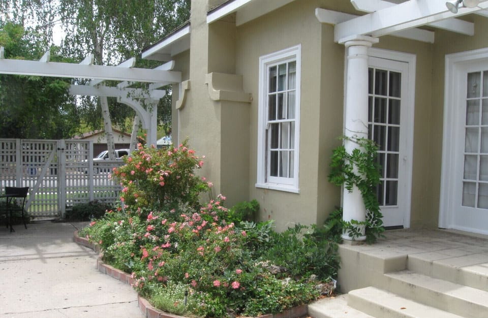 Garden plantings soften the walk to the front entry