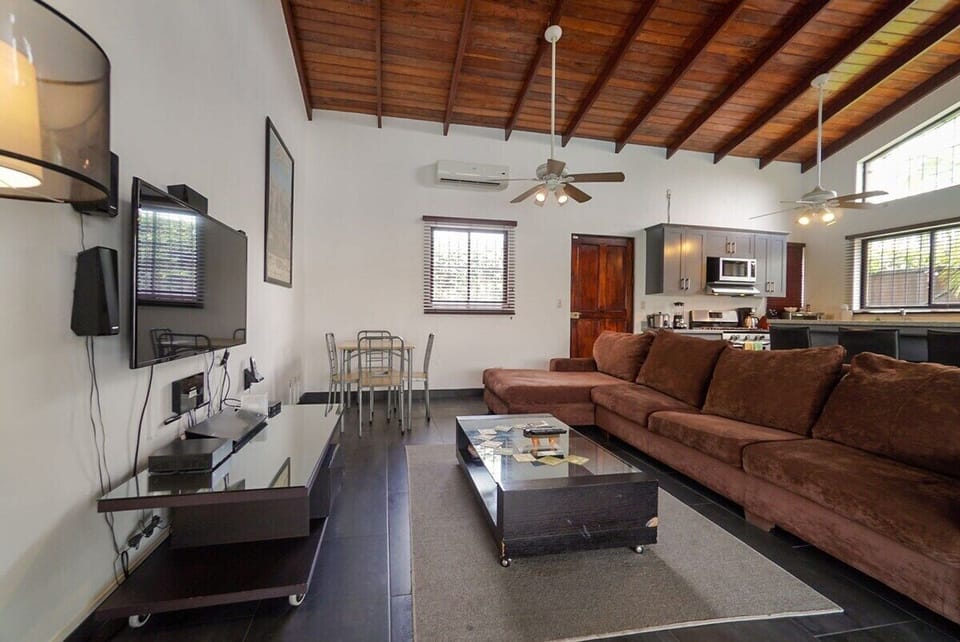 Living room with flatscreen TV and Home Theater, L-shaped sofa.