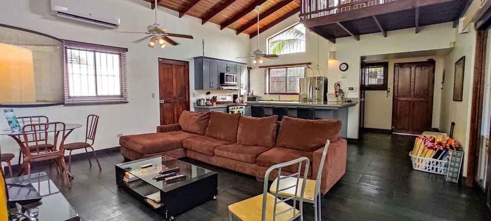 Living room with flatscreen TV and Home Theater, L-shaped sofa.