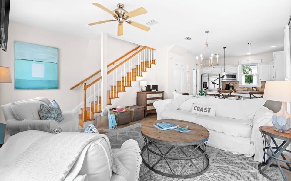 Unwind in this bright, open living space with cozy seating, coastal touches, and smooth access to your fully-equipped kitchen—perfect for lounging or entertaining after a beach day.