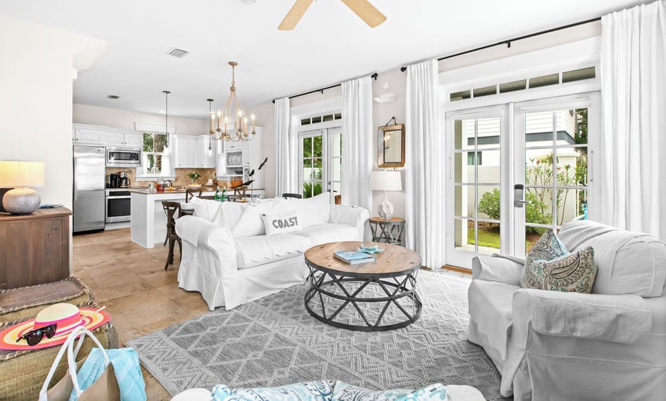 Step into your bright coastal retreat—fresh whites, breezy natural light, and a seamless flow from the cozy living room to your fully equipped kitchen invite you to relax and feel right at home.