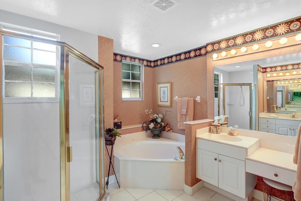VY693-16B - The en-suite master bathroom features a spacious walk-in shower, roman tub and dual sinks