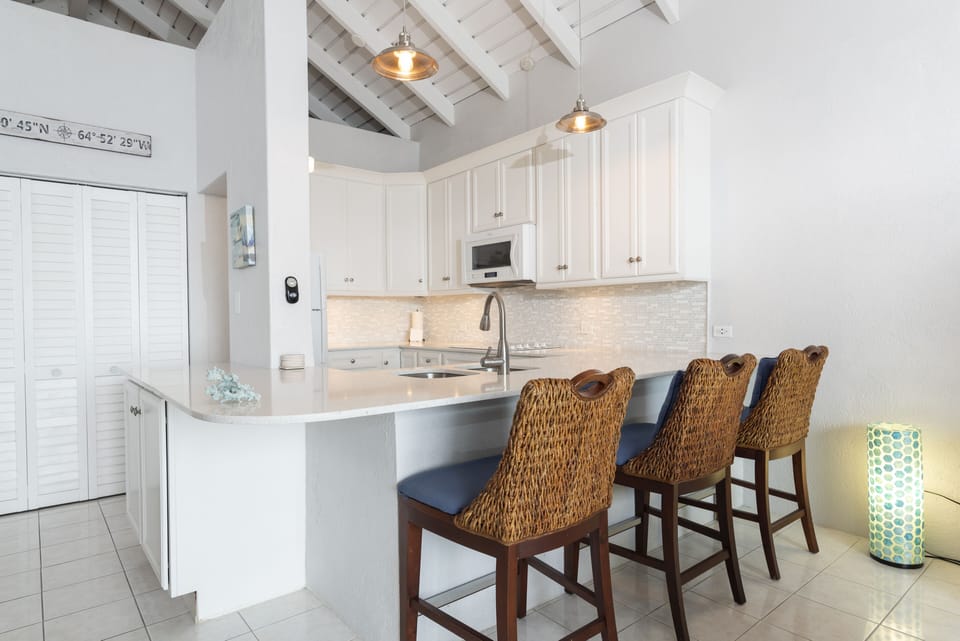 Kitchen - Bar stools provide extra seating at the kitchen counter.