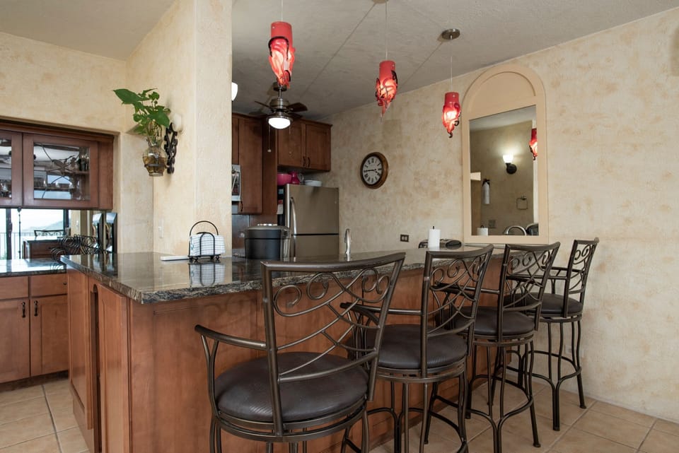Bar stool seating at kitchen counter.