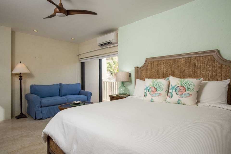King size bedroom with second sleeper sofa and access to terrace.