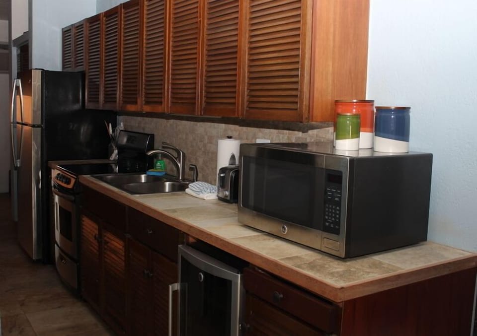 Fully equipped kitchen with wine cooler.