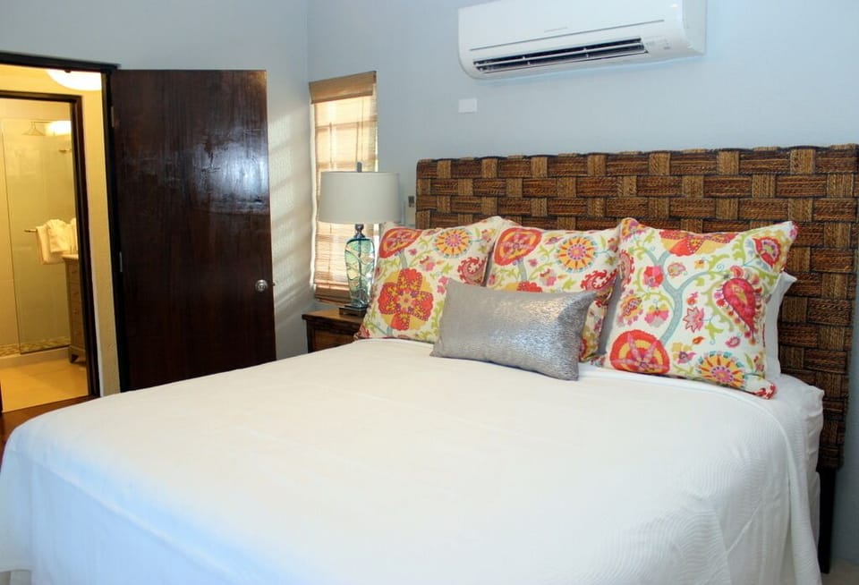 King size bedroom with sliding bamboo shutters for privacy.