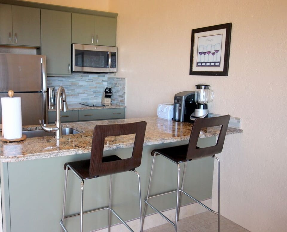 Fully renovated kitchen with barstool seating.