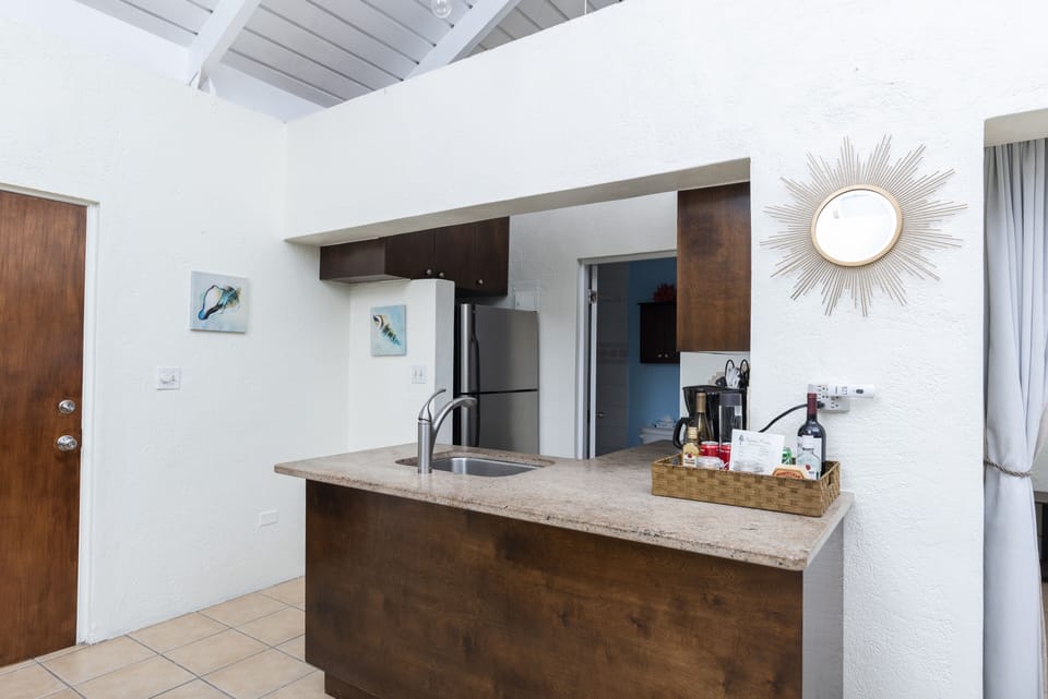 Enter the villa into the kitchen and dining area.