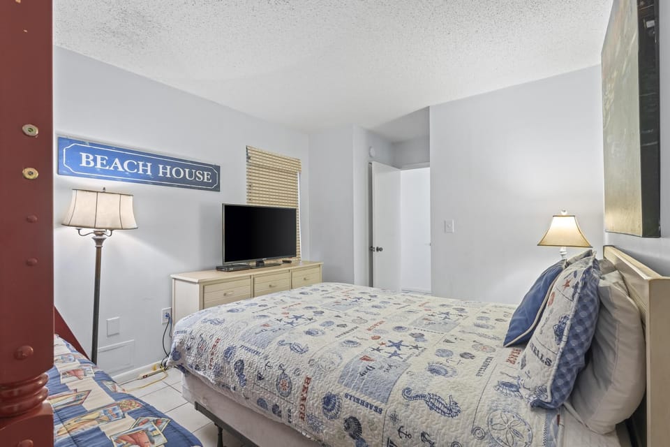 Guest Bedroom - The guest bedroom features Queen bedding, a dresser for storing your personal belongings, and also a television for enjoying in your down time.