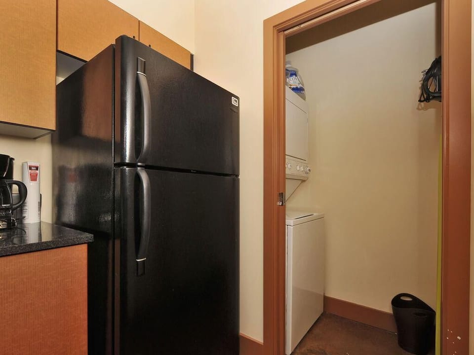 Travel light! Enjoy the ultimate convenience of your own private laundry facilities hidden right off the kitchen space.