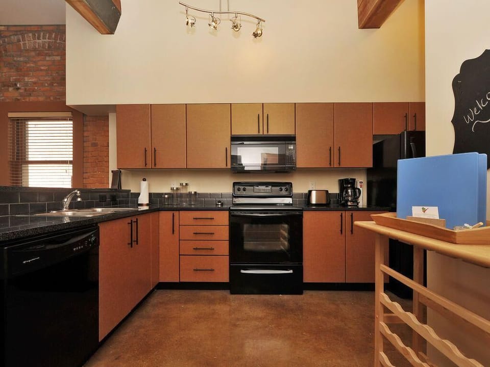 Everything you need and more! A full view of the expansive kitchen, complete with a modern stove, built-in microwave, and ample counter space.