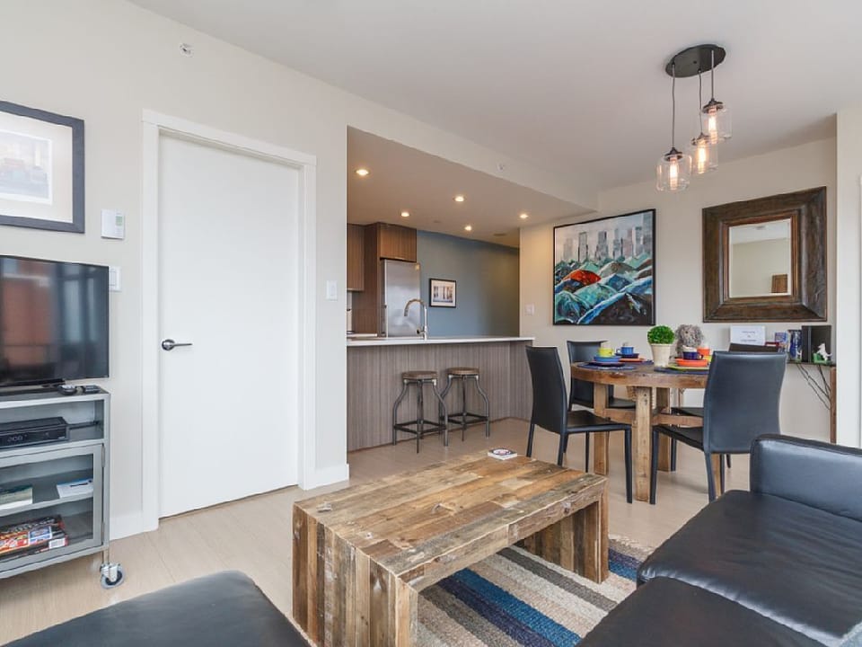 Living and dining area with modern kitchen access