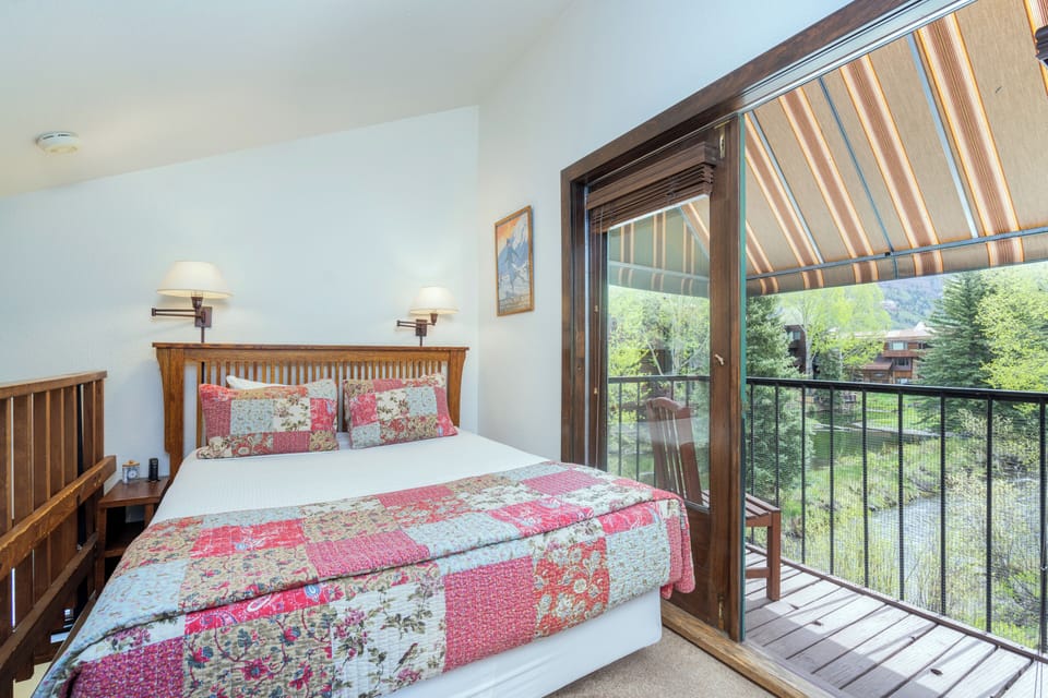 Wake up to fresh mountain air and green views just beyond your private balcony. Cozy linens and warm wood accents make this your perfect retreat after a day of adventure.
