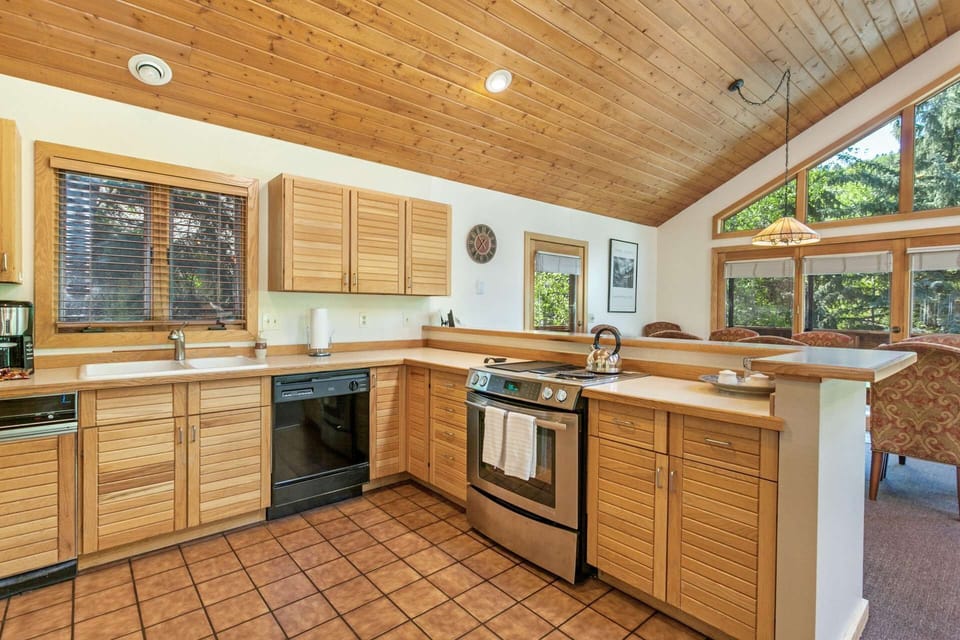 Feel part of the group when cooking in the spacious fully equipped kitchen that opens to the living and dining areas.