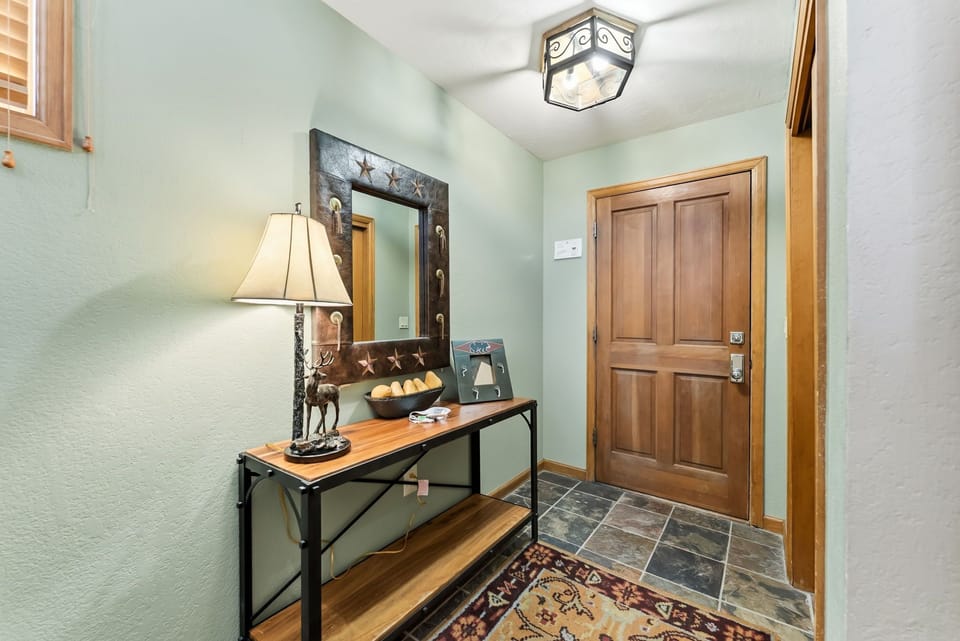 Step into your welcoming entryway with rustic charm, where warm wood tones and thoughtful decor create the perfect first impression of home.