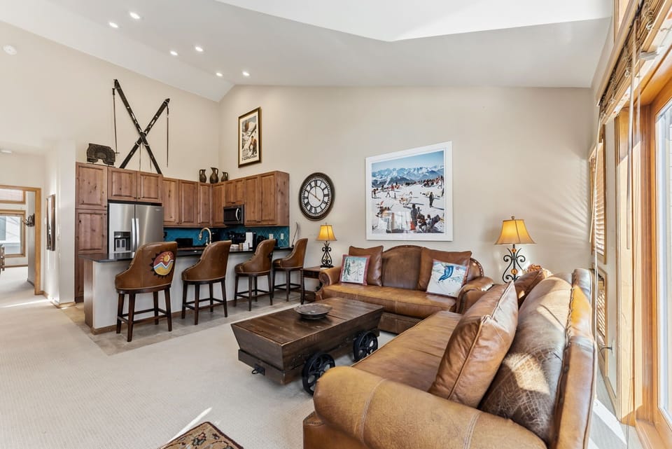 Relax in this inviting open-plan living space where rustic warmth meets modern comfort, perfect for unwinding after your mountain adventures.