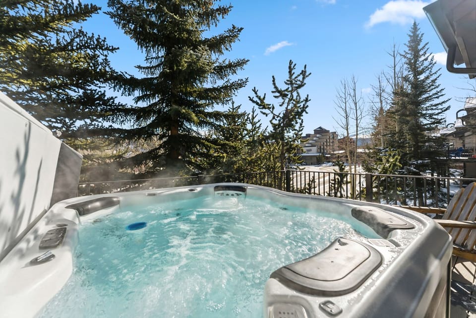 Unwind in your private hot tub while soaking up mountain views and crisp winter air on this peaceful balcony retreat.