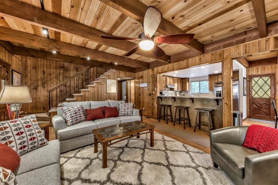 Relax in your cozy living room with rustic wood beams, comfortable seating, and an open layout perfect for gathering with loved ones.