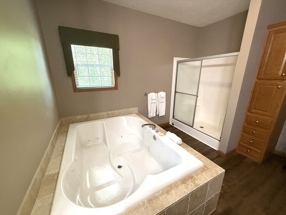 Primary Bathroom 1 with Walk-In Shower & Whirlpool Tub on Main Level