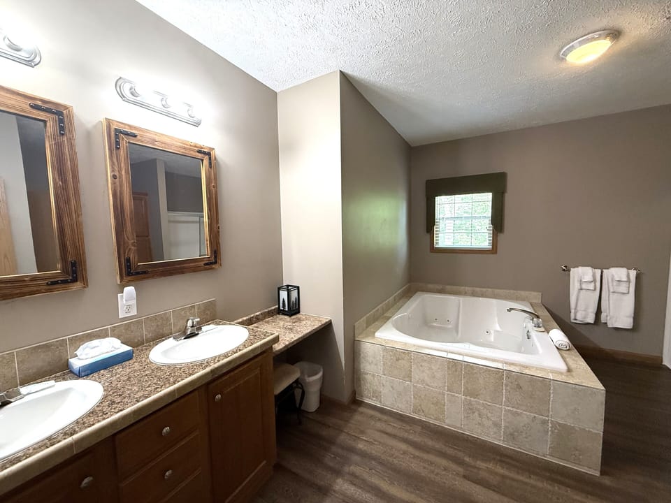 Primary Bathroom 1 with Walk-In Shower & Whirlpool Tub on Main Level