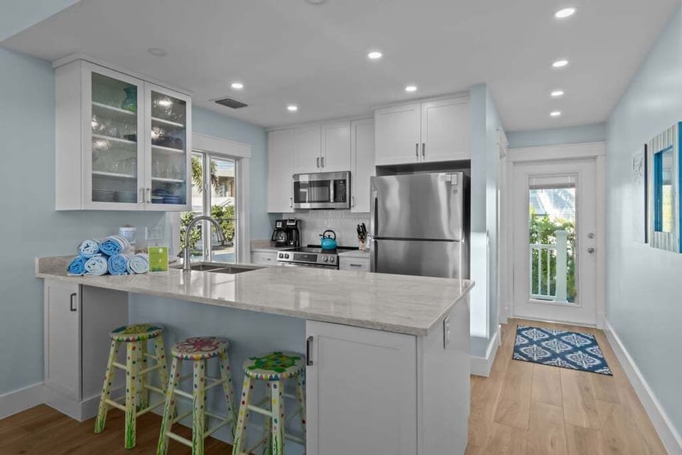 Kitchen with stainless steel appliances and a breakfast bar