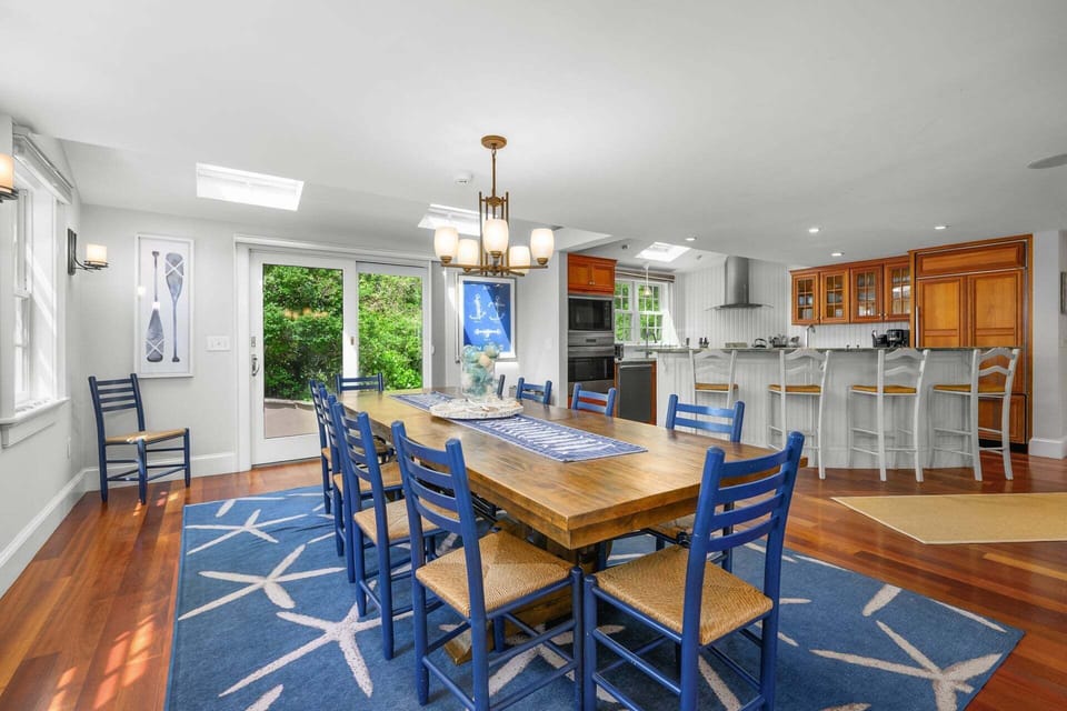 Creating connection between the living room and kitchen is the dining area with seating for ten
